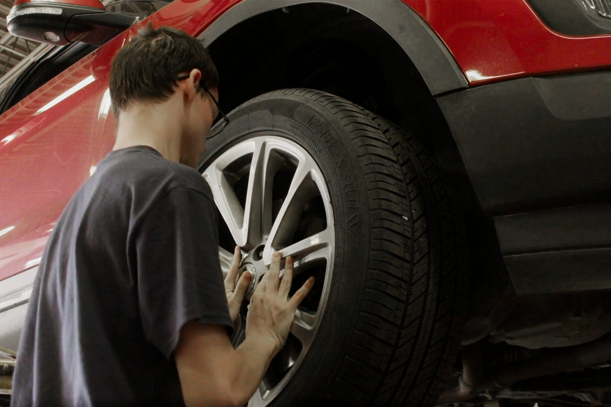 Automtove Technology student putting tire on vehicle
